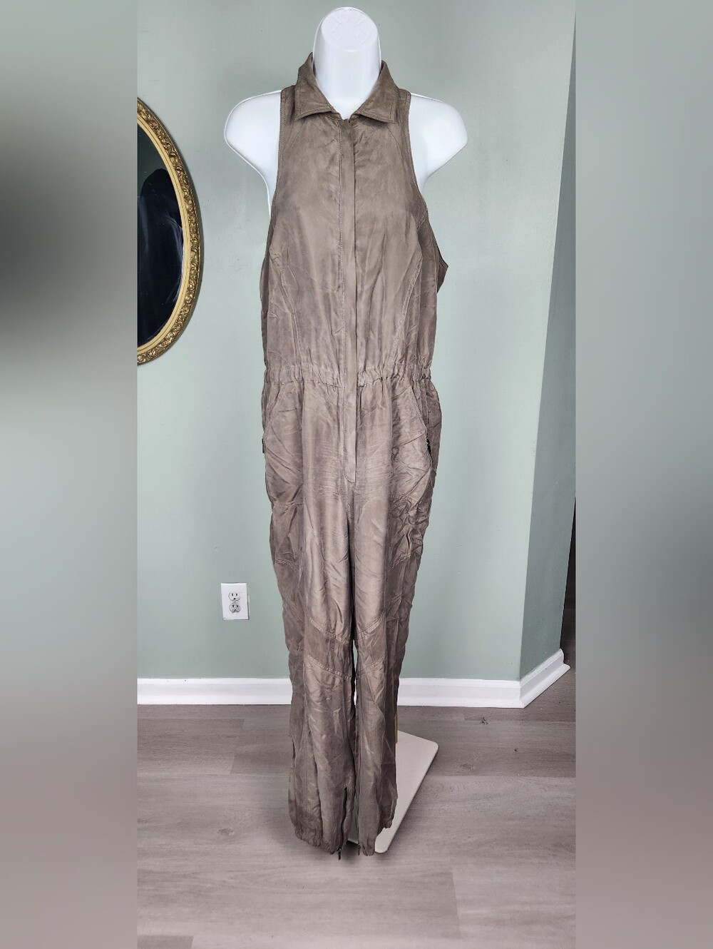 A vintage olive green silk jogger-style jumpsuit.